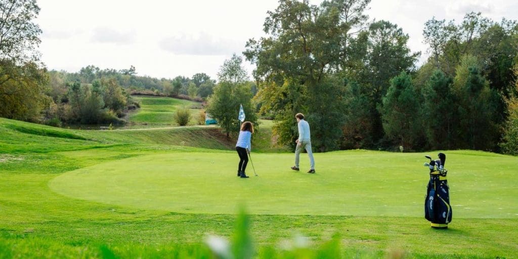 two golfers teeing off at Golf de la Marterie
