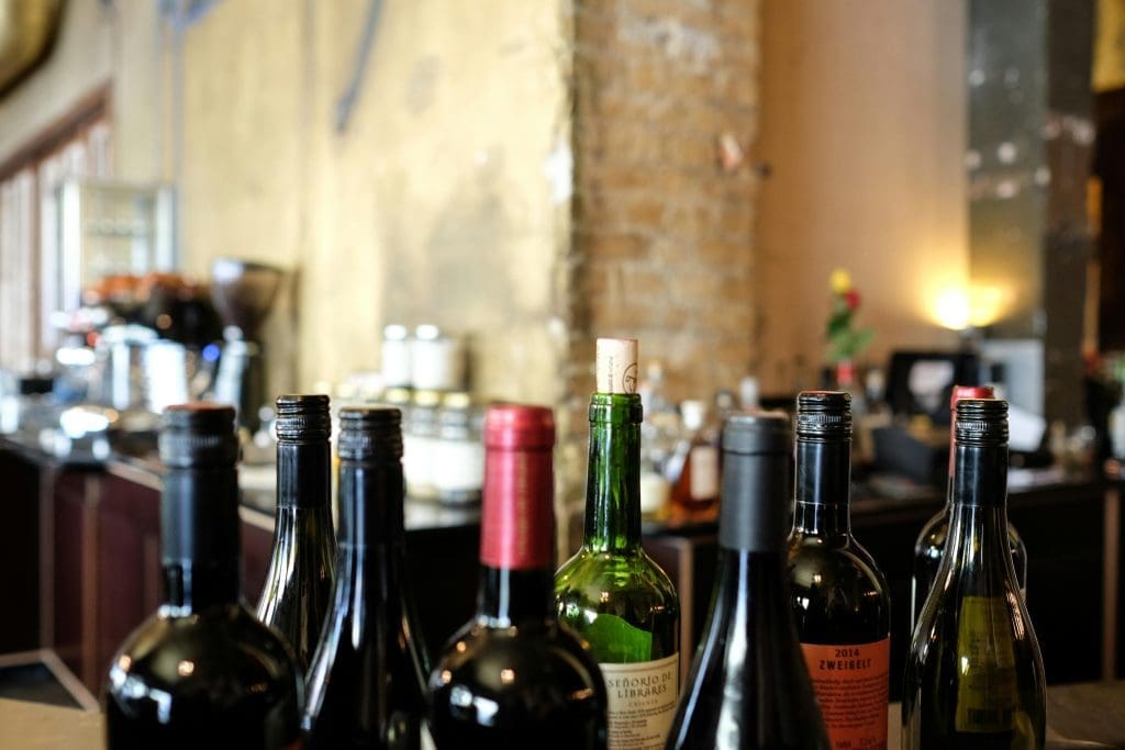 People enjoying glasses of wine in a cozy wine bar in the Dordogne, France
