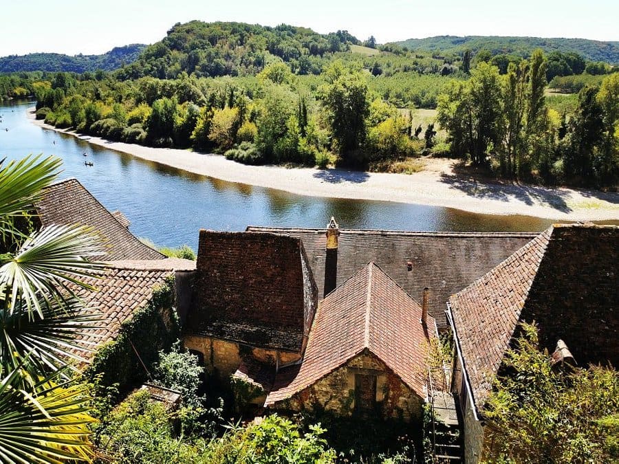 View over rooftops and the Dordogne River in La Roque Gageac microclimate